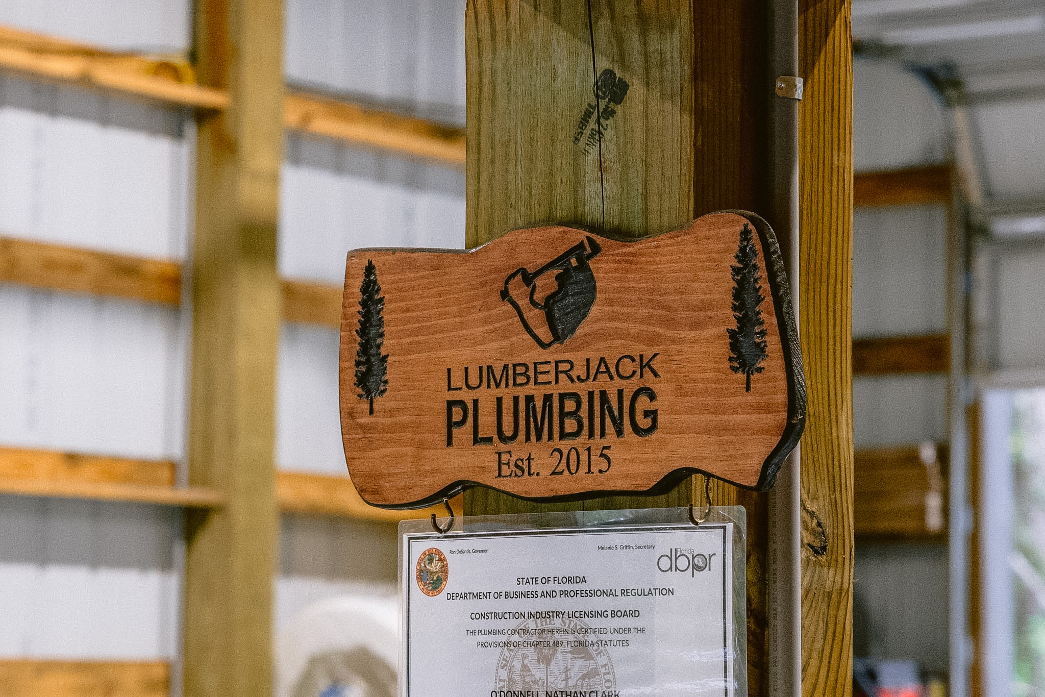 Lumberjack Plumbing wood sign and state certification